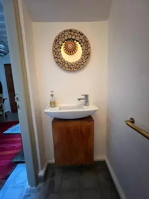 a bathroom with a sink and a mirror on the wall at Riad EL BADIS in Marrakech