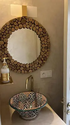 a bathroom with a sink and a mirror at Riad EL BADIS in Marrakech
