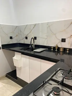 a kitchen with a stove and a counter top at Cosy urbain in Marrakech
