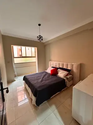 a bedroom with a bed and a window in it at Cosy urbain in Marrakech