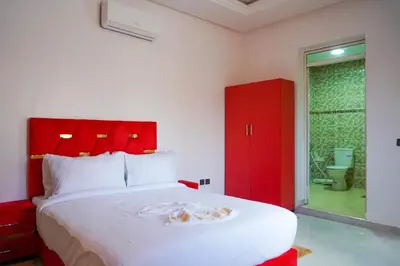 a bedroom with a large bed with a red headboard at Marrakesh villa 1 in Marrakech