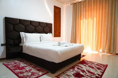 a bedroom with a large bed and a large window at Marrakesh villa 1 in Marrakech