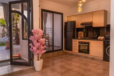 a kitchen with a vase with pink flowers in it at Villa loujain in Marrakech