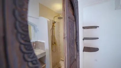 a bathroom with a shower next to a door at Riad 2 Ksour Marrakesh in Marrakech