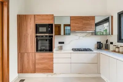 a kitchen with white counters and wooden cabinets at Villa Bahia Luxury-Pool Breakfast & Golf Access in Marrakech