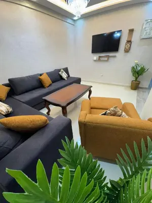 a living room with couches and a flat screen tv at Apartment in Marrakech in Marrakech