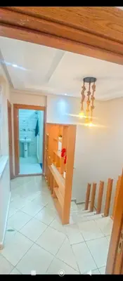 a kitchen with a table and a dining room at Appartement DUPLEX in Marrakech