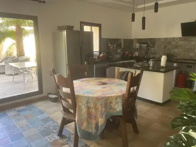 a kitchen with a table with a table cloth on it at Studio avec SDB salon tele kitchenette privé dans une villa piscine, calme et commodités in Marrakech