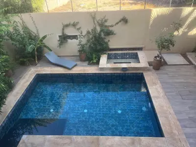 a small swimming pool in a yard with plants at Studio avec SDB salon tele kitchenette privé dans une villa piscine, calme et commodités in Marrakech