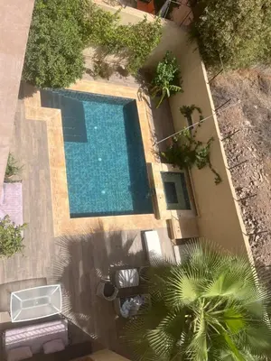 an overhead view of a swimming pool next to a building at Studio avec SDB salon tele kitchenette privé dans une villa piscine, calme et commodités in Marrakech