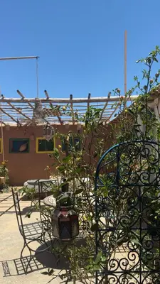 a table and chairs in front of a building at Farm stay in Marrakech