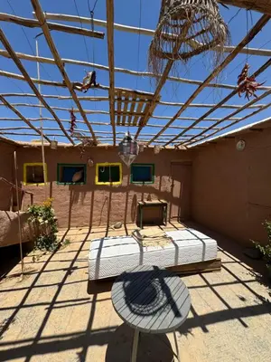 a room with a bed in the middle of a building at Farm stay in Marrakech