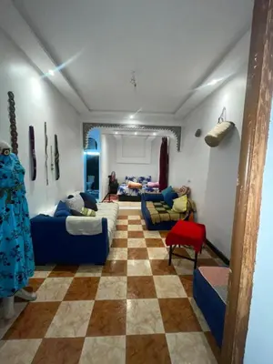 a living room with couches and a checkered floor at Suite 2 in Marrakech
