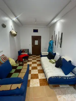 a living room with a couch and a checkerboard floor at Suite 2 in Marrakech