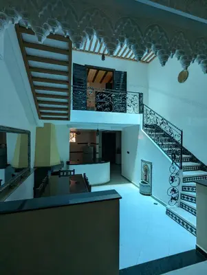 a view of a living room with a spiral staircase at Riad du village in Marrakech