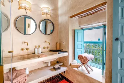 a bathroom with a sink and two mirrors at Riad Dar Palma Heated Pool Jacuzzi Heart Of Marrakech Medina in Marrakech