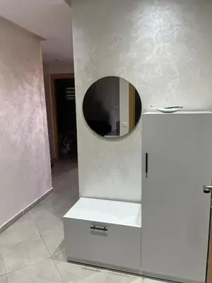 a room with a mirror and a white refrigerator at Brand new cozy apartment in Marrakech