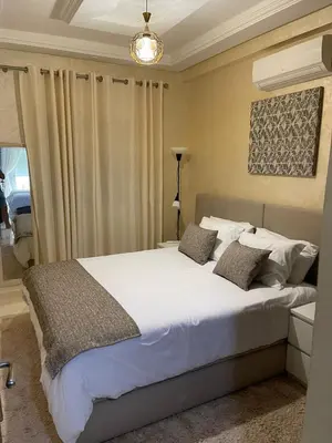 a bedroom with a large white bed with two pillows at Luxurious and charming apartment in Marrakech