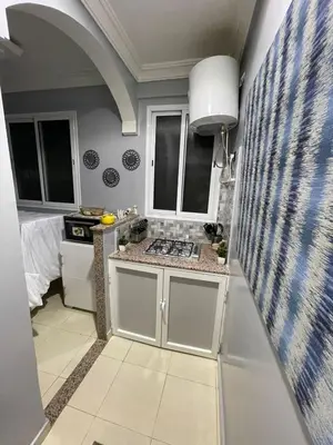 a kitchen with a sink and a stove at Luxurious and charming apartment in Marrakech