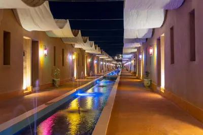 a hallway with a pool of water in a building at Al destino Resort Marrakech in Marrakech