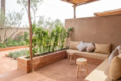 a patio with a couch and a table at Al destino Resort Marrakech in Marrakech