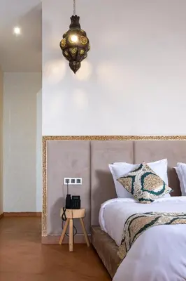 a bedroom with a bed and a chandelier at Al destino Resort Marrakech in Marrakech
