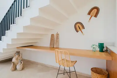 a staircase in a house with a desk and chairs at Duplex Style and Confortable au Centre de la Ville in Marrakech
