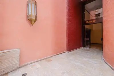 an empty hallway of a building with a light on the wall at Duplex Style and Confortable au Centre de la Ville in Marrakech