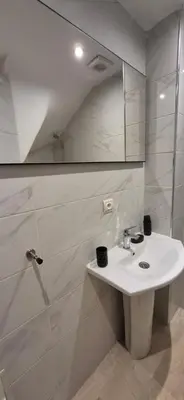 a white bathroom with a sink and a shower at Sérénité en plein Marrakech in Marrakech
