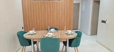 a wooden table with chairs and a wooden wall at Elegant & Chic Retreat, Pool, Prime Location in Marrakech