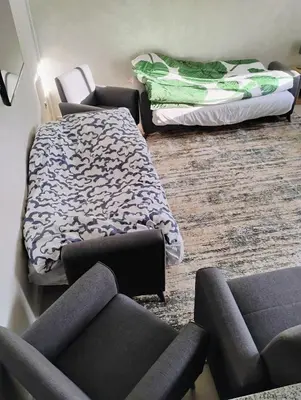 a living room with three chairs and a bed at Home sweet home in Marrakech in Marrakech