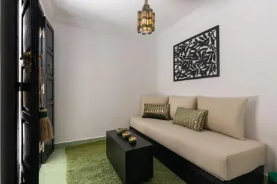 a living room with a couch and a table at Riad Zehra in Marrakech