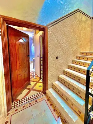 a set of stairs in a room with a door at Marakech home in Marrakech