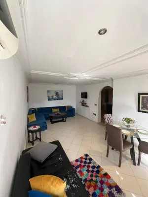 a living room with a couch and a table at Cozy appartement en plein coeur de Guéliz in Marrakech