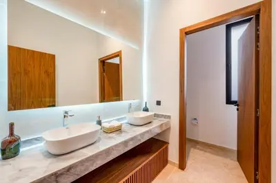 a bathroom with two sinks and a large mirror at Sumptuous Villa, Heated Pool, 15minutes to City Center, Daily Housekeeping, Private Cook and Chauffeur, Games in Marrakech