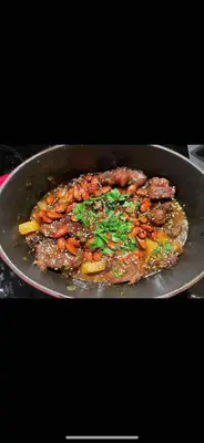 a pan of food with meat and vegetables at Villa Grenade in Marrakech