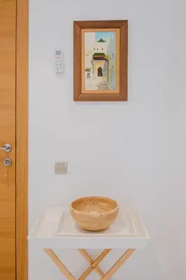 a bowl on a table with a picture on the wall at 3 Bedroom Apartment with Pool View Prestigia in Marrakech