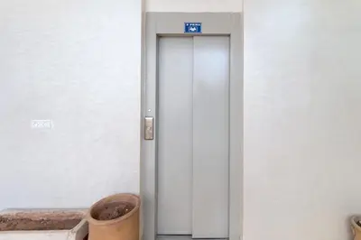 a white elevator with a blue sign on it at Studio calme au cœur de Marrakech Guiliz, proche Victor Hugo in Marrakech