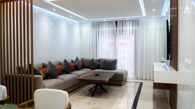 a living room with a couch and a table at Appartement de luxe au cœur du quartier majorelle in Marrakech