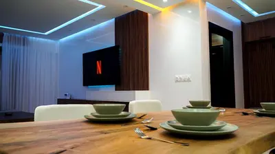 a wooden table with green bowls and plates on it at Appartement de luxe au cœur du quartier majorelle in Marrakech