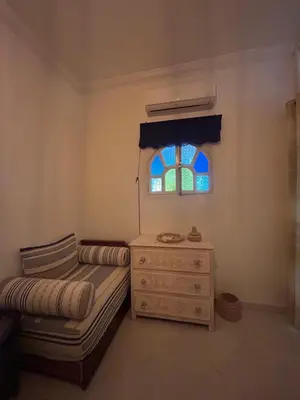 a small bedroom with a bed and a window at Maison à la Palmeraie avec piscine et parking à Marrakech in Marrakech
