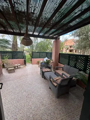 an outdoor patio with couches and tables and a ceiling at Maison à la Palmeraie avec piscine et parking à Marrakech in Marrakech