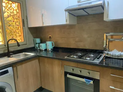 a kitchen with a stove top oven next to a sink at Mon paradis Golf & Piscine in Marrakech