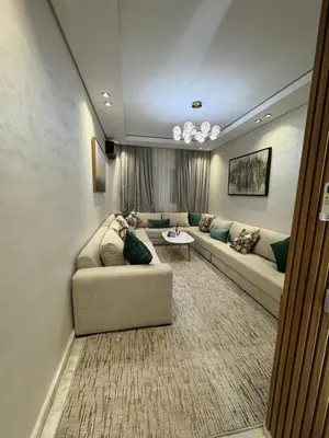 a living room with a couch and a table at Résidence Soulaymane اقامة سليمان in Marrakech