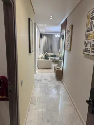 a hallway leading to a living room with a couch at Résidence Soulaymane اقامة سليمان in Marrakech