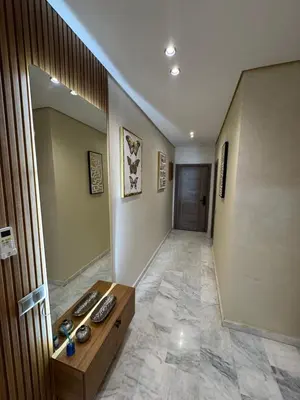 a room with a hallway with a table and a mirror at Résidence Soulaymane اقامة سليمان in Marrakech