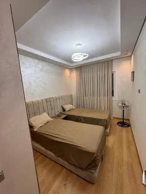 a hotel room with two beds and a couch at Résidence Soulaymane اقامة سليمان in Marrakech
