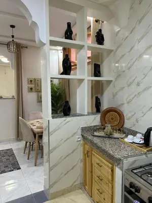 a kitchen with white marble walls and a counter at Apartment in Marrakech , Near Jamaa El Fna in Marrakech