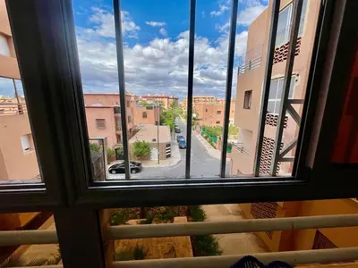 a view of a city street from a window at Beautiful family apartment with parking in Marrakech