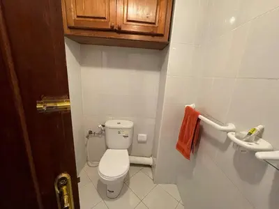 a small bathroom with a toilet and a sink at Beautiful family apartment with parking in Marrakech